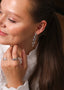 Nærbilde av en kvinne med Daisy Flower øredobber i sølv med hvite cubic zirconia stener.