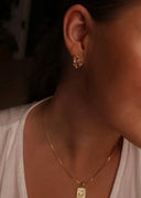 Nærbilde av melodie øredobb i rosa